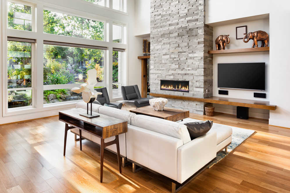 mid-century modern living room with white leather couch and gray accent chairs