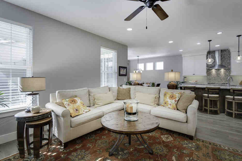 traditional living room with round wood coffee table and cream-colored couch