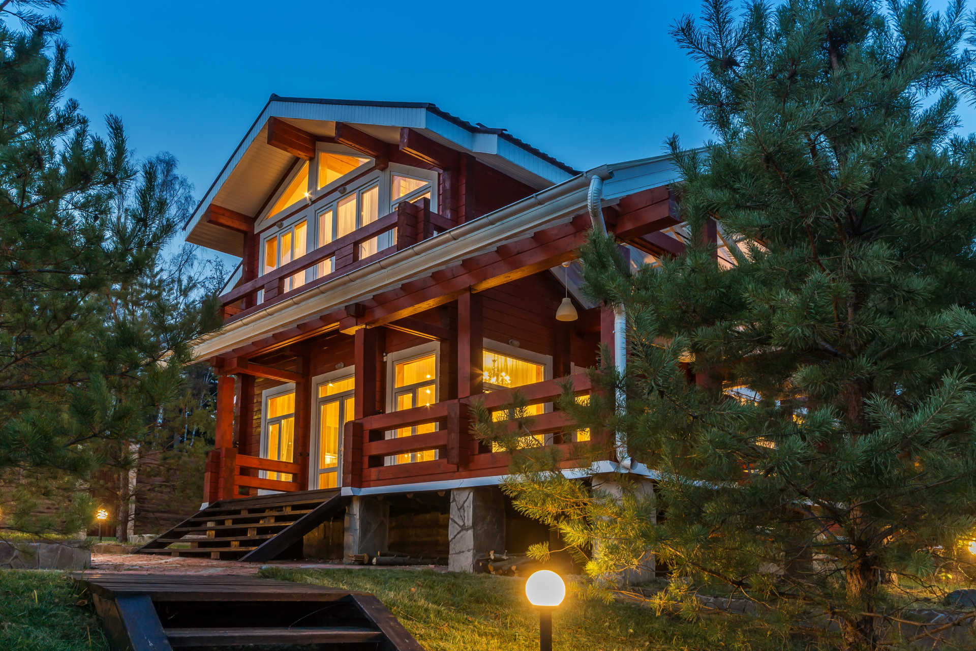 TWILIGHT photo of a country home with pine trees